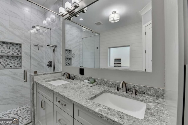 bathroom featuring vanity and an enclosed shower