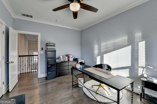 home office featuring ceiling fan, ornamental molding, and dark wood-type flooring