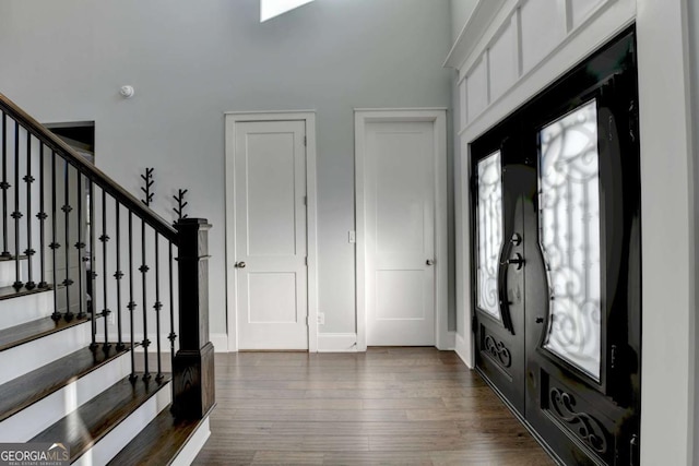 entryway with dark hardwood / wood-style flooring