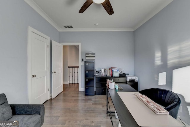 office featuring ceiling fan, wood-type flooring, and ornamental molding