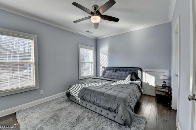 bedroom featuring ceiling fan, dark hardwood / wood-style flooring, and ornamental molding