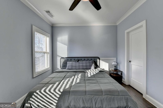 bedroom with hardwood / wood-style floors, ceiling fan, and crown molding