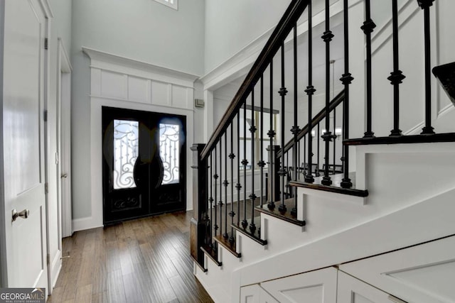 foyer entrance featuring french doors and dark wood-type flooring