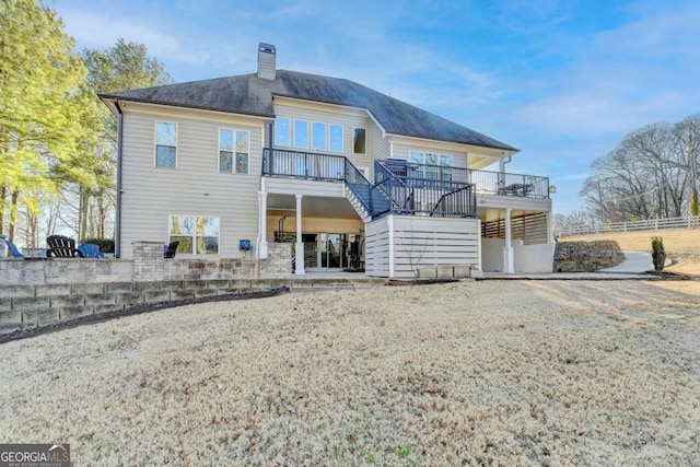 back of house featuring a wooden deck