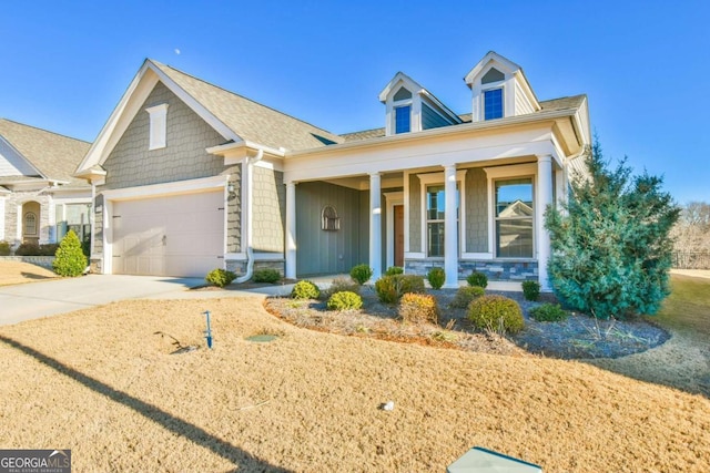 view of front of property featuring covered porch and a garage