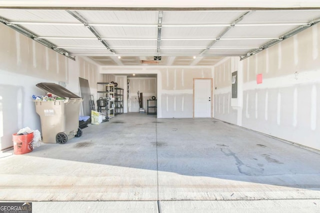 garage with electric panel and a garage door opener