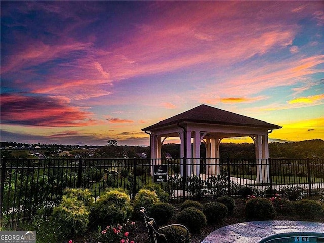 patio terrace at dusk featuring a gazebo