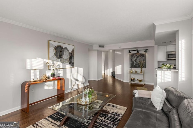 living room featuring dark wood-type flooring, ornamental molding, and plenty of natural light