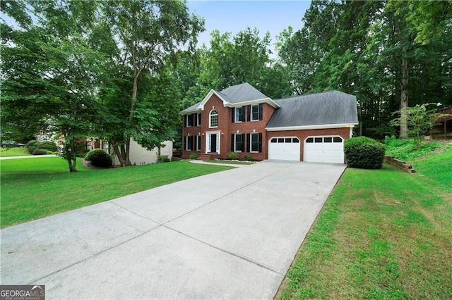 colonial inspired home featuring a garage and a front lawn