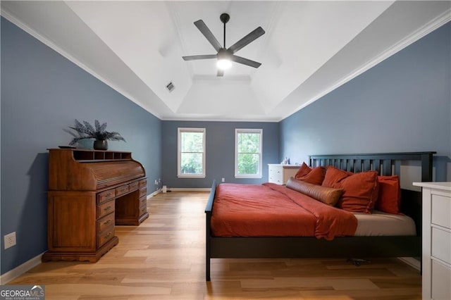 bedroom with a raised ceiling, ceiling fan, and light hardwood / wood-style flooring