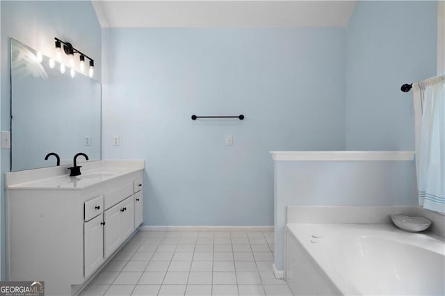 bathroom with tile patterned flooring, vanity, and a bathing tub