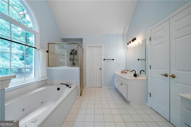 bathroom featuring a healthy amount of sunlight, vaulted ceiling, and independent shower and bath