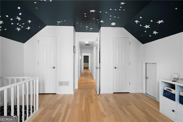 bonus room with hardwood / wood-style floors and lofted ceiling