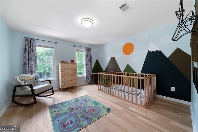 bedroom with light hardwood / wood-style floors