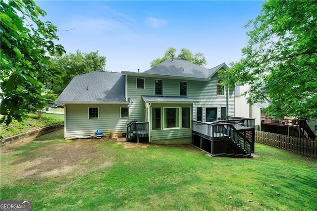 back of house with a yard and a wooden deck