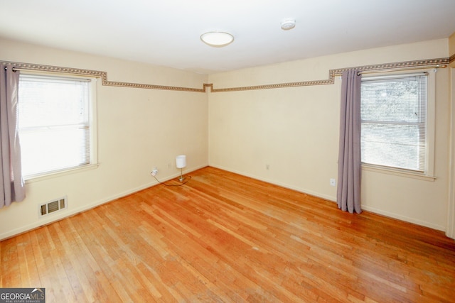 unfurnished room featuring hardwood / wood-style floors