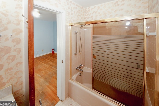 bathroom with shower / bath combination with glass door