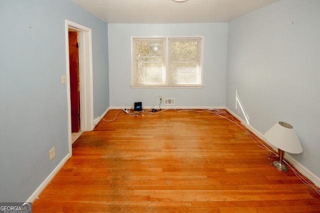 spare room with hardwood / wood-style floors