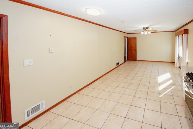 empty room featuring ceiling fan, light tile patterned floors, and crown molding