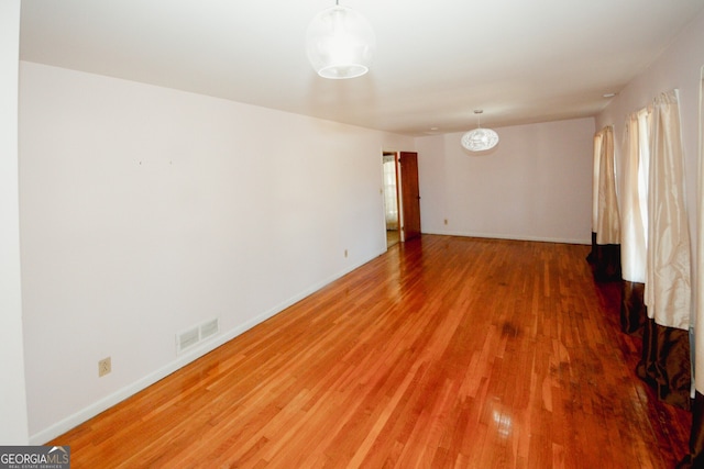 unfurnished room featuring hardwood / wood-style floors