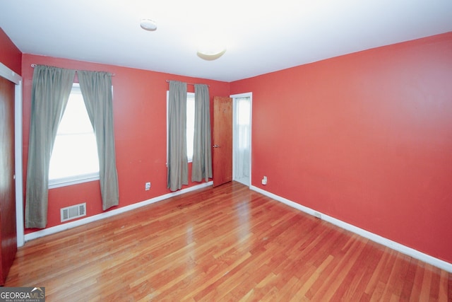 spare room featuring wood-type flooring