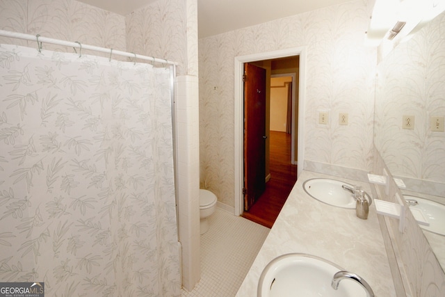 bathroom featuring toilet, tile patterned flooring, and vanity