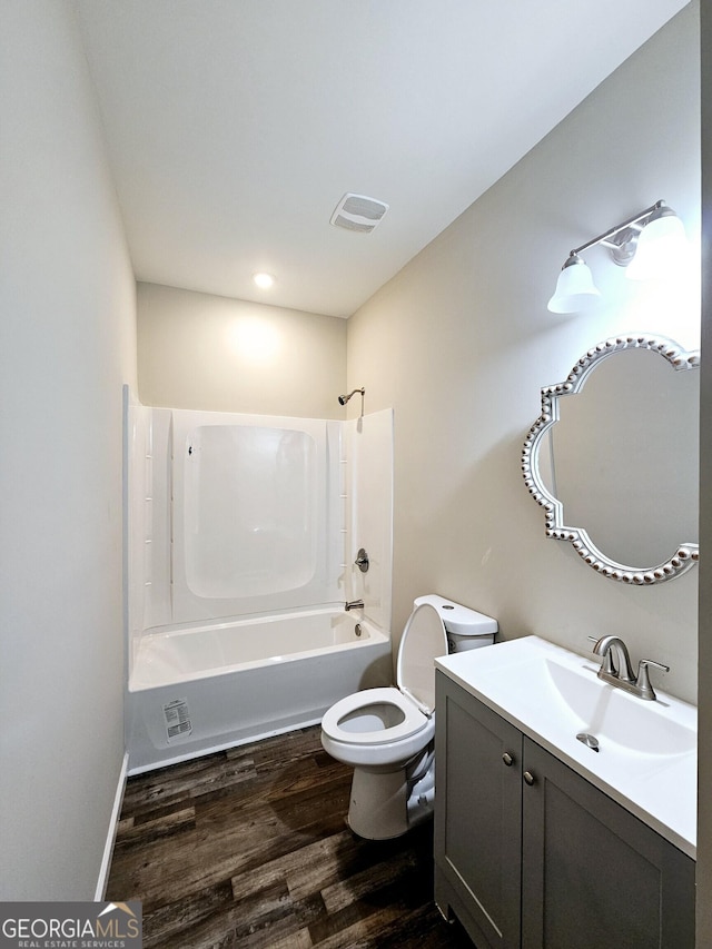 full bathroom featuring toilet, shower / bath combination, hardwood / wood-style flooring, and vanity