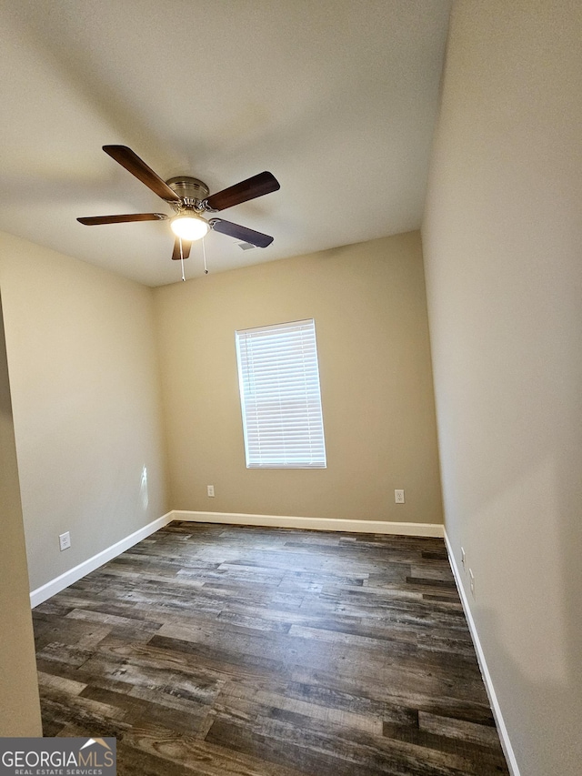 spare room featuring ceiling fan and dark hardwood / wood-style flooring