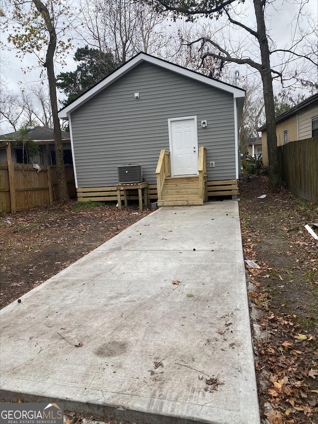 rear view of property featuring central AC unit