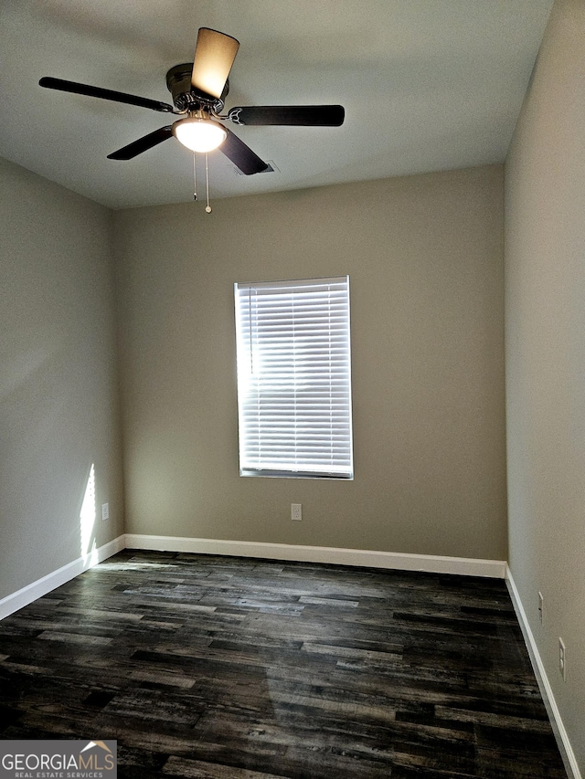 empty room with ceiling fan and dark hardwood / wood-style floors