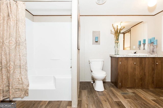 full bathroom with hardwood / wood-style flooring, ornamental molding, vanity, and toilet