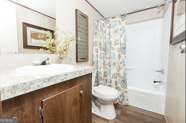 full bathroom with hardwood / wood-style flooring, vanity, toilet, and shower / tub combo