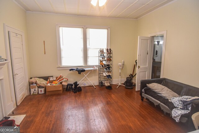 interior space with crown molding and dark wood-type flooring