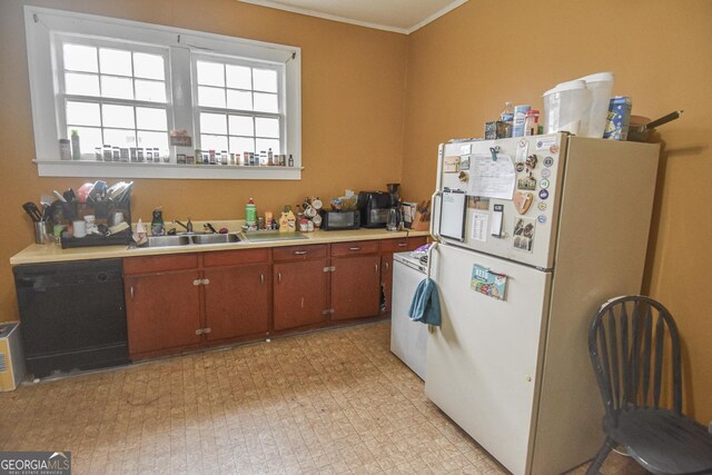 kitchen featuring sink, ornamental molding, black dishwasher, white fridge, and washer / clothes dryer