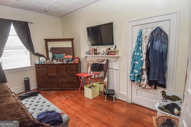 bedroom featuring hardwood / wood-style flooring and ornamental molding