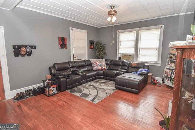 living room with crown molding, cooling unit, and hardwood / wood-style flooring