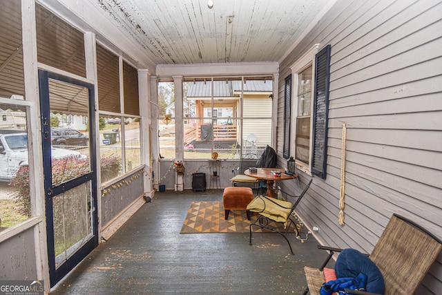 unfurnished sunroom with wood ceiling