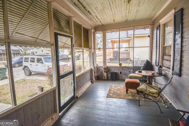 sunroom / solarium featuring a wealth of natural light and wood ceiling