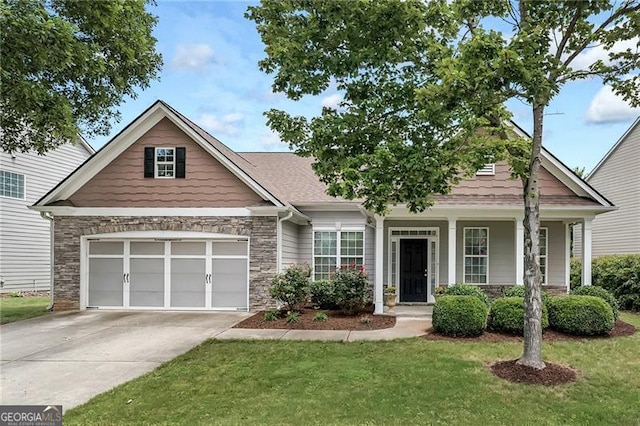 craftsman-style home featuring a porch, a garage, and a front lawn