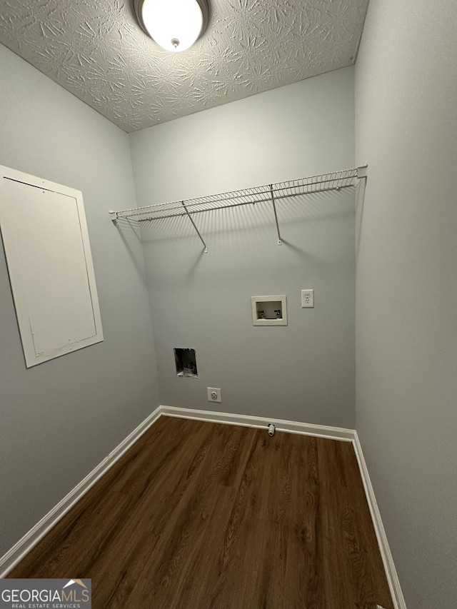 laundry room featuring washer hookup, a textured ceiling, dark hardwood / wood-style floors, and electric dryer hookup