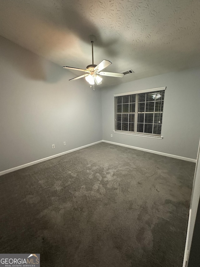 carpeted empty room featuring a textured ceiling and ceiling fan