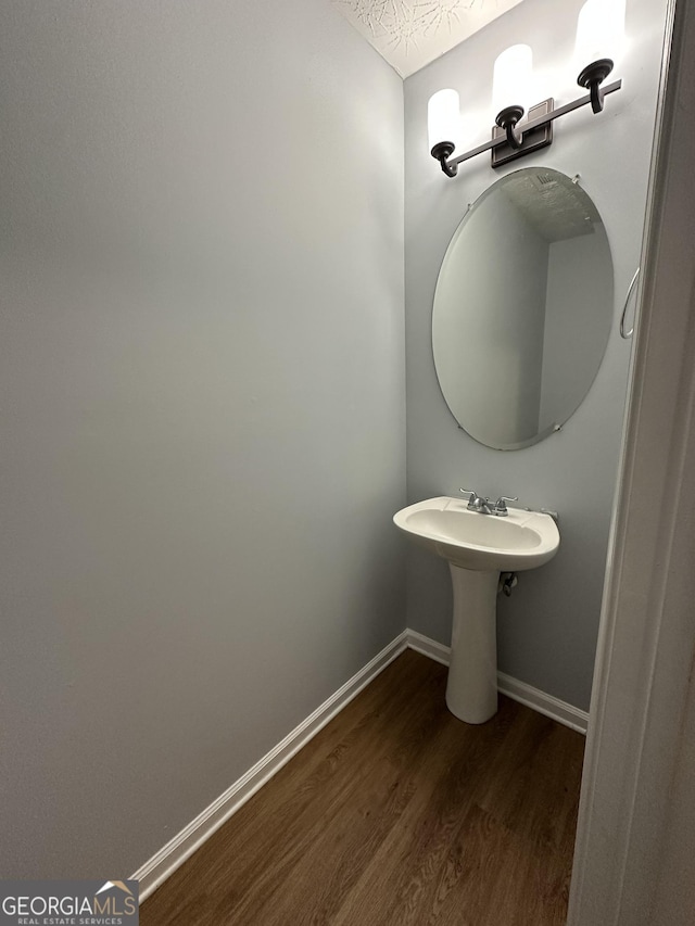 bathroom featuring hardwood / wood-style floors and a textured ceiling