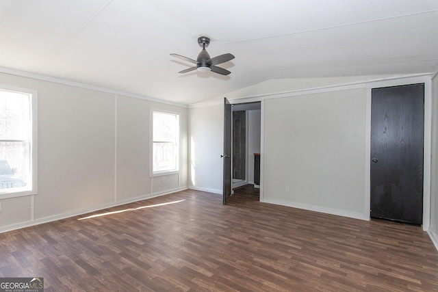 unfurnished room with dark hardwood / wood-style floors, vaulted ceiling, ceiling fan, and a healthy amount of sunlight