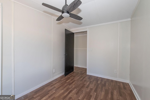 unfurnished bedroom featuring ceiling fan and dark hardwood / wood-style floors