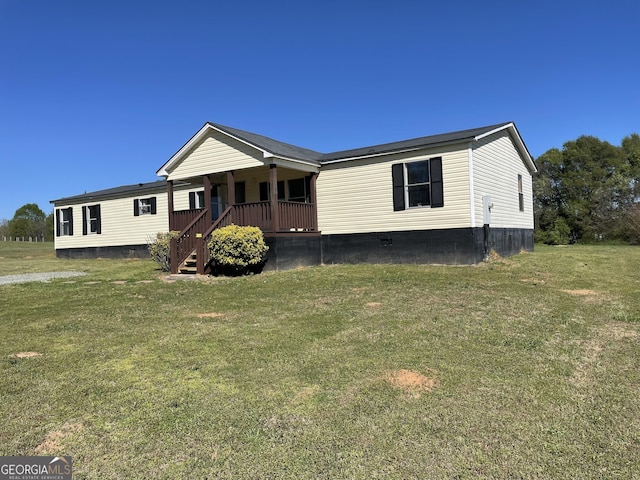 manufactured / mobile home with a front lawn and a porch