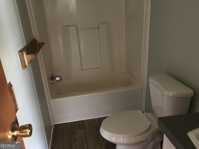 full bathroom with toilet, vanity, tub / shower combination, and hardwood / wood-style flooring