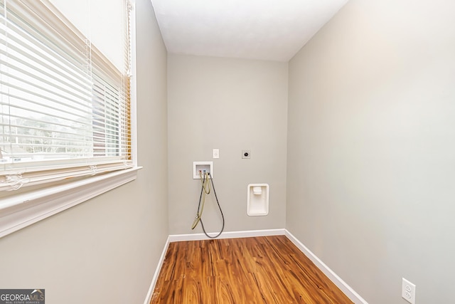 clothes washing area with hardwood / wood-style flooring, hookup for an electric dryer, and hookup for a washing machine