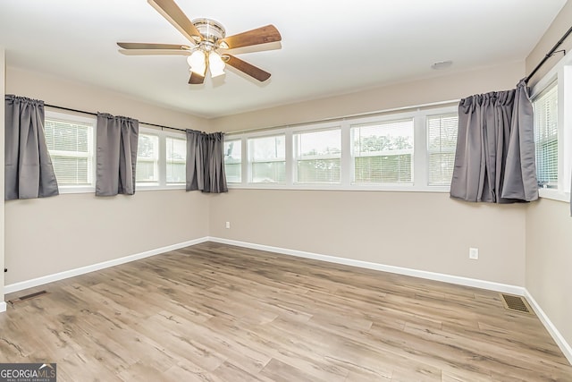 empty room featuring ceiling fan and light hardwood / wood-style flooring