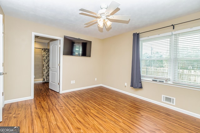 unfurnished bedroom with ceiling fan and wood-type flooring