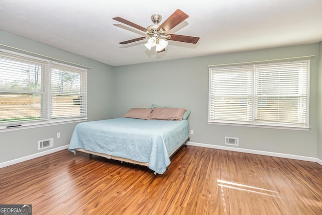 bedroom featuring wood-type flooring and ceiling fan